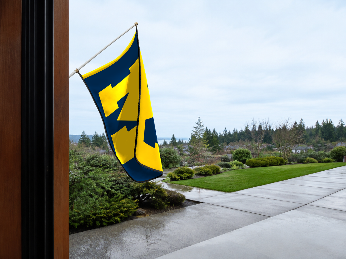 Michigan Wolverines Authentic Gameday Flag — approved one-scene environment view — EXO R89 — item_id=ncaa-fbs-michigan-wolverines — source_sha256=ecef8f23a2b9ccf2786097f5b3058773b11606387ae8298c71fae99f3e9bf94b