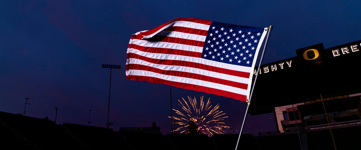 EXO PHOTOGRAPHY / EDER USA FLAG / HERO / reinforced-fly United States flag at a stadium with fireworks / real product photography