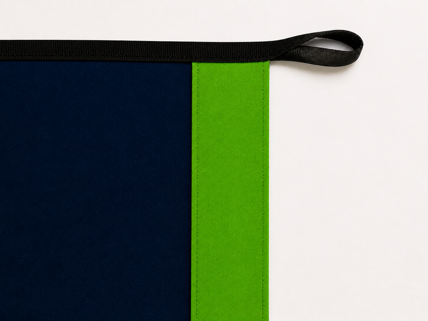 Seattle Authentic Gameday Flag header underside and personalization side, showing the full Action Green sewn header, navy face, black loop and reinforced edge without a logo tag.