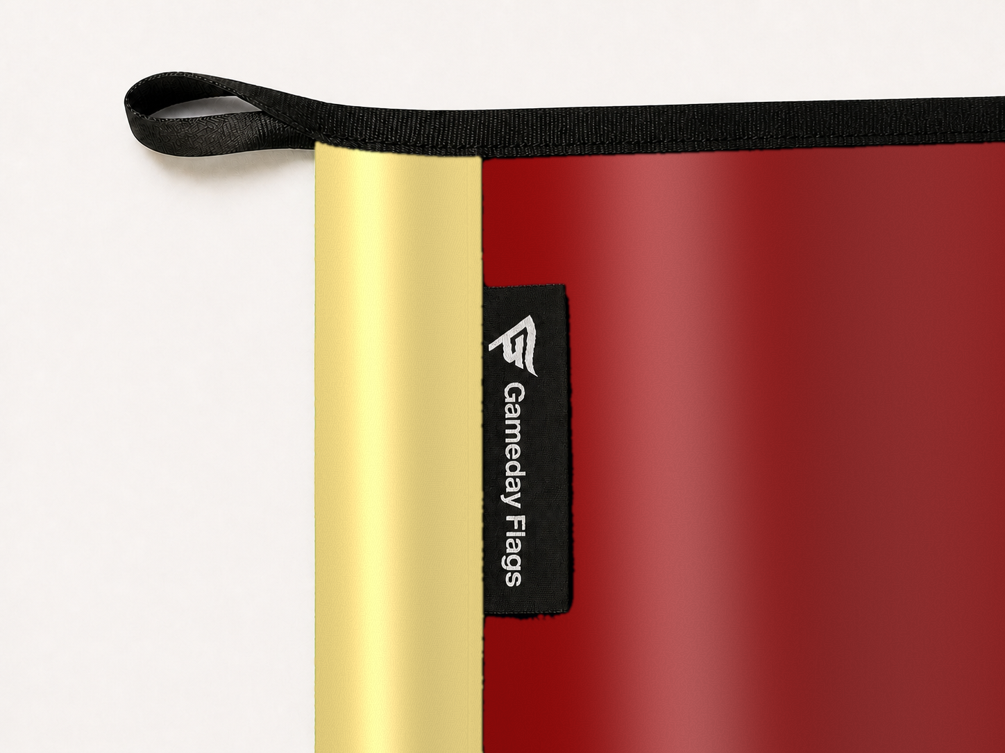 Barcelona Authentic Gameday Flag construction detail — restrained woven-satin Barcelona Accent sewn header, textured Barcelona Primary face, woven Gameday Flags tag, black loop, perimeter webbing, and stitching — source_sha256=00176f6e10162cffca46980df45468f5556d8b7ab2a59e5e0d3cd559e535cec0