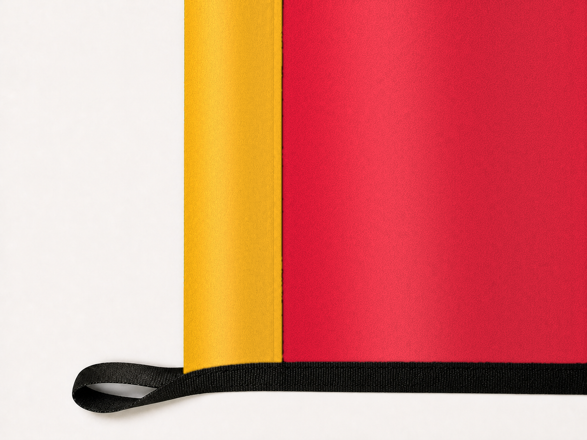 Kansas City Chiefs Authentic Gameday Flag underside and personalization construction view — continuous restrained woven-satin Kansas City Chiefs Accent header, textured Kansas City Chiefs Primary face, lower black loop and perimeter webbing — source_sha256=be84ffd19342125425e538161a2907bddc0cba14338863fb60bb4d6762568c70