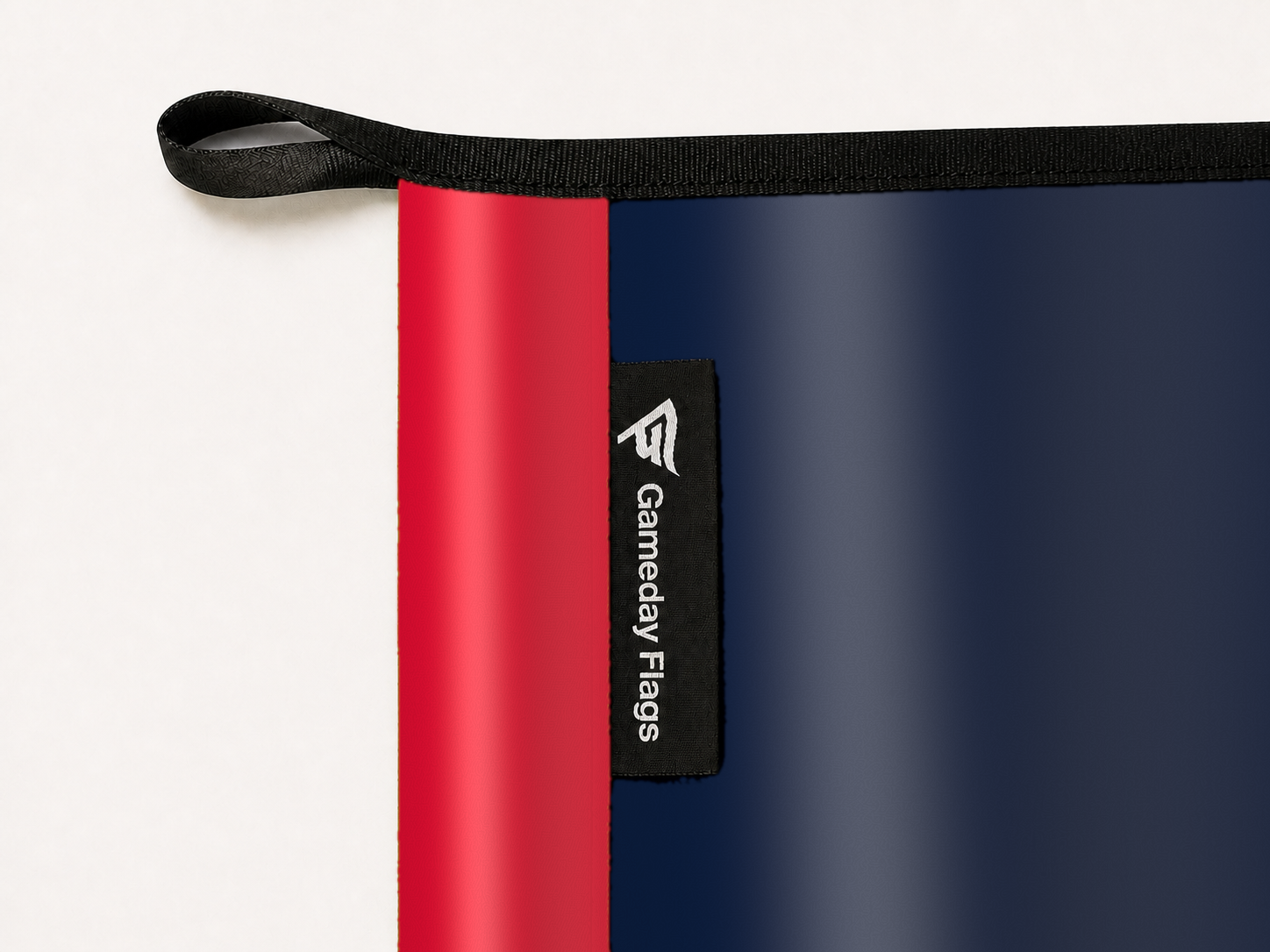 Minnesota Twins Authentic Gameday Flag construction detail — restrained woven-satin Minnesota Twins Accent sewn header, textured Minnesota Twins Primary face, woven Gameday Flags tag, black loop, perimeter webbing, and stitching — source_sha256=0c71a7ddc00e27fea1d3daed69fc41fb9ad45964861bdda828b37a1c0d6921db