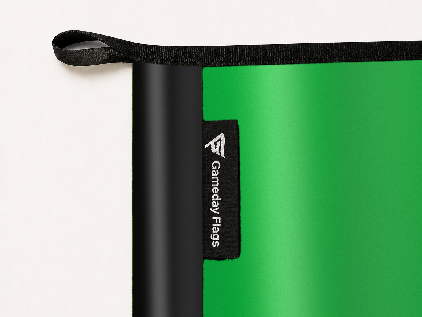 Austin FC Authentic Gameday Flag construction detail — restrained woven-satin Austin FC Accent sewn header, textured Austin FC Primary face, woven Gameday Flags tag, black loop, perimeter webbing, and stitching — source_sha256=68af1c91547eb2b1d112ec5d3bec5642b68601b8de81b6a1497d2e992203be26