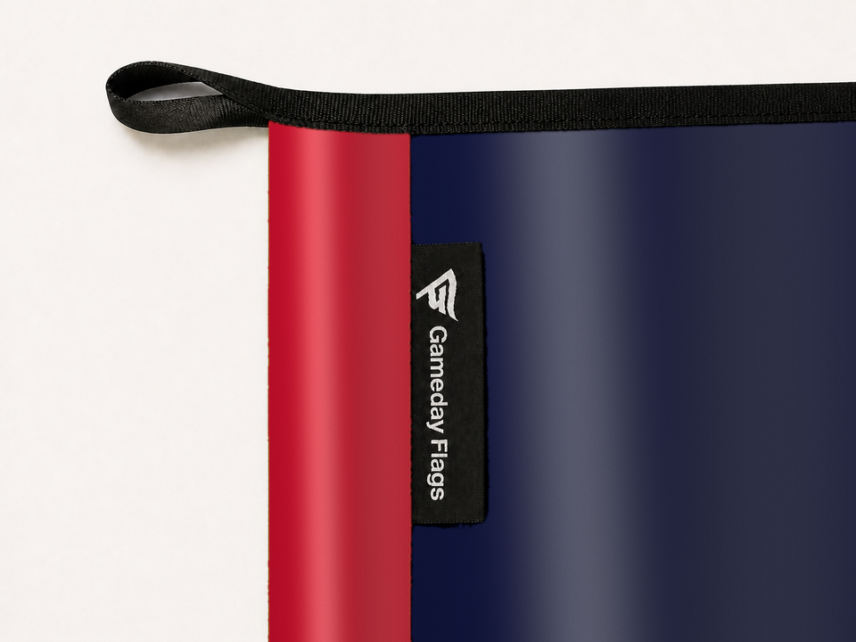 LA Clippers Authentic Gameday Flag construction detail — restrained woven-satin LA Clippers Accent sewn header, textured LA Clippers Primary face, woven Gameday Flags tag, black loop, perimeter webbing, and stitching — source_sha256=0562c1c7d03f897ffc67e7eff137bde5781a8a2830c0e83ecc7ba5023ce47ce2