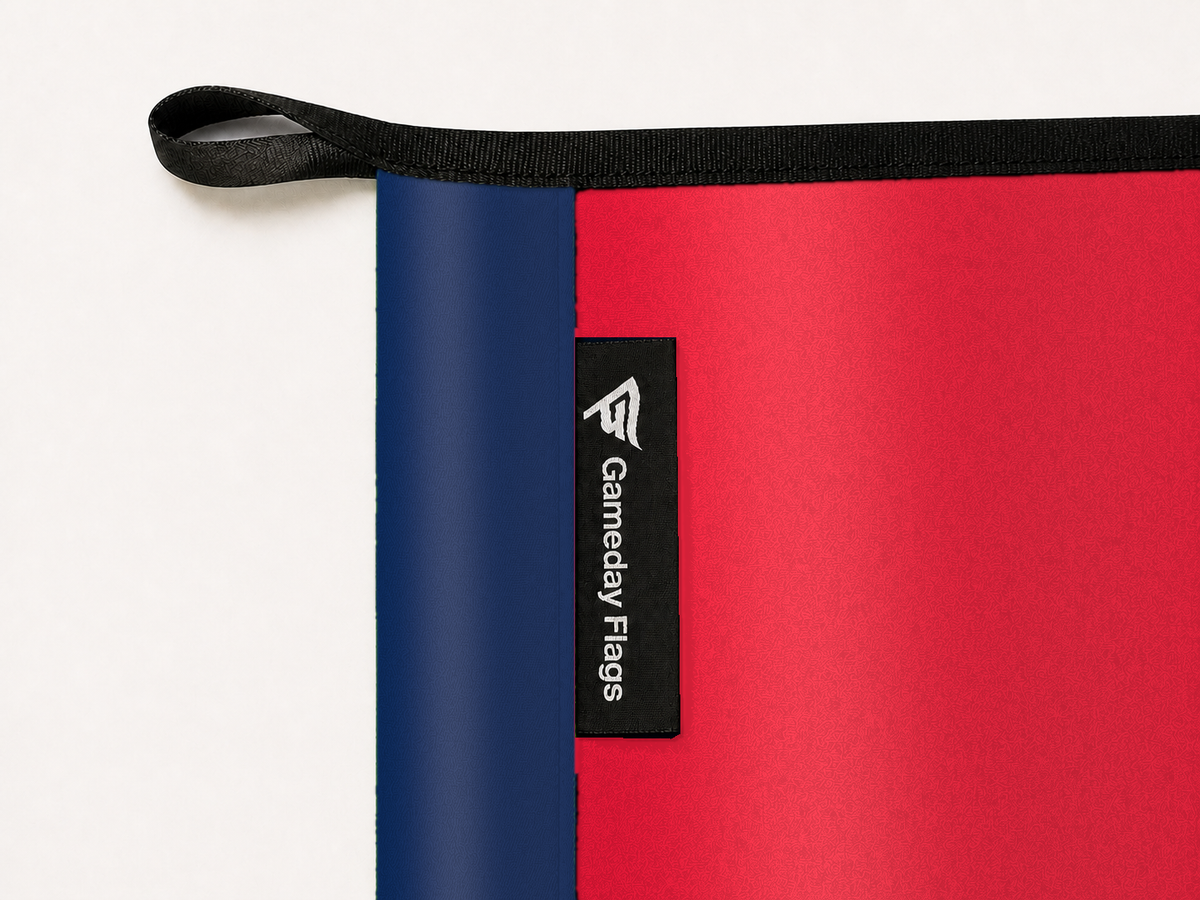 Washington Wizards Authentic Gameday Flag construction detail — restrained woven-satin Washington Wizards Accent sewn header, textured Washington Wizards Primary face, crisp woven Gameday Flags tag and controlled contact shadow, black loop, perimeter webbing, and stitching — source_sha256=4166956a9c23f7e3e8624268de9a3be23f75747d6754c1e114808e9852eb3868