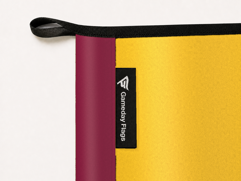 Arizona State Sun Devils Authentic Gameday Flag construction detail — restrained woven-satin Arizona State Sun Devils Accent sewn header, textured Arizona State Sun Devils Primary face, crisp woven Gameday Flags tag and controlled contact shadow, black loop, perimeter webbing, and stitching — source_sha256=0cac0eeae42f68e000e4b0e5c2fe3edc21466515c8b8773a174987755c2af22c