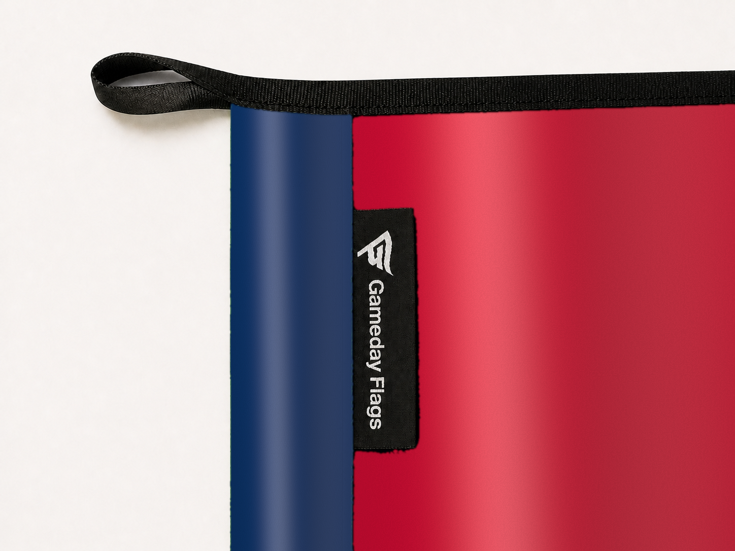 Arizona Wildcats Authentic Gameday Flag construction detail — restrained woven-satin Arizona Wildcats Accent sewn header, textured Arizona Wildcats Primary face, woven Gameday Flags tag, black loop, perimeter webbing, and stitching — source_sha256=ba4140cc0adfa2c74ab230ceebd940d970d48a3ecf55f8da17799b312c57e7a2