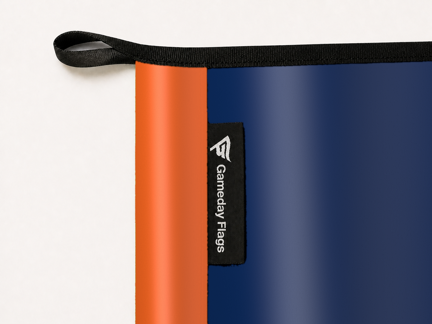 Auburn Tigers Authentic Gameday Flag construction detail — restrained woven-satin Auburn Tigers Accent sewn header, textured Auburn Tigers Primary face, woven Gameday Flags tag, black loop, perimeter webbing, and stitching — source_sha256=2a8a1b66b7b595ab7c6ffb050c14de231112804106319c73330ebef2dc6d0fdd