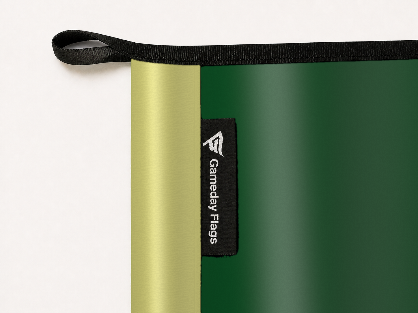 Colorado State Rams Authentic Gameday Flag construction detail — restrained woven-satin Colorado State Rams Accent sewn header, textured Colorado State Rams Primary face, woven Gameday Flags tag, black loop, perimeter webbing, and stitching — source_sha256=302bfca1187b161ca55297496ed1af1190dd5e47a9506446abb66be12a78ed2d