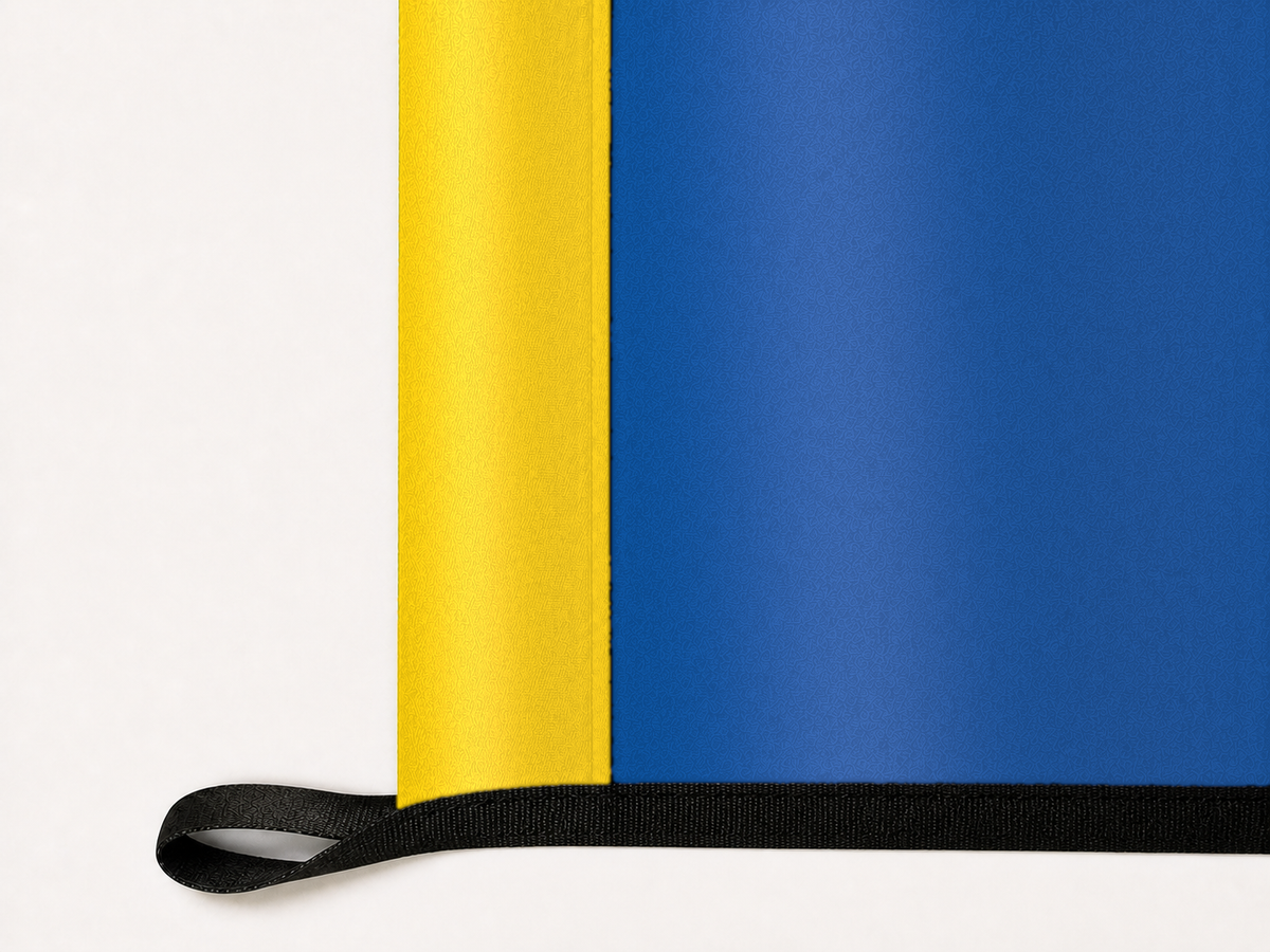 Delaware Blue Hens Authentic Gameday Flag underside and personalization construction view — continuous restrained woven-satin Delaware Blue Hens Accent header, textured Delaware Blue Hens Primary face, lower black loop and perimeter webbing — source_sha256=fd074933b206730f407b40005f362e34528c82dad52715135c1998a8034d20af