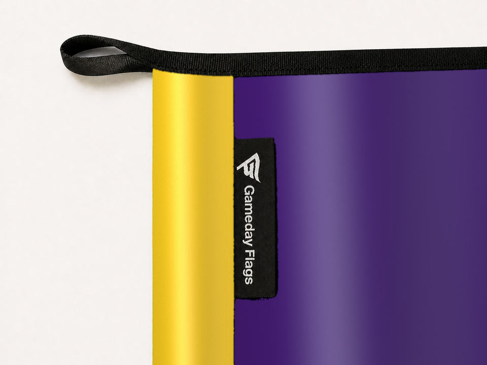 LSU Tigers Authentic Gameday Flag construction detail — restrained woven-satin LSU Tigers Accent sewn header, textured LSU Tigers Primary face, woven Gameday Flags tag, black loop, perimeter webbing, and stitching — source_sha256=bae89f0b271c20691b3abfe702f9e4997b7b7d8e14cdef626e81d173812fd594