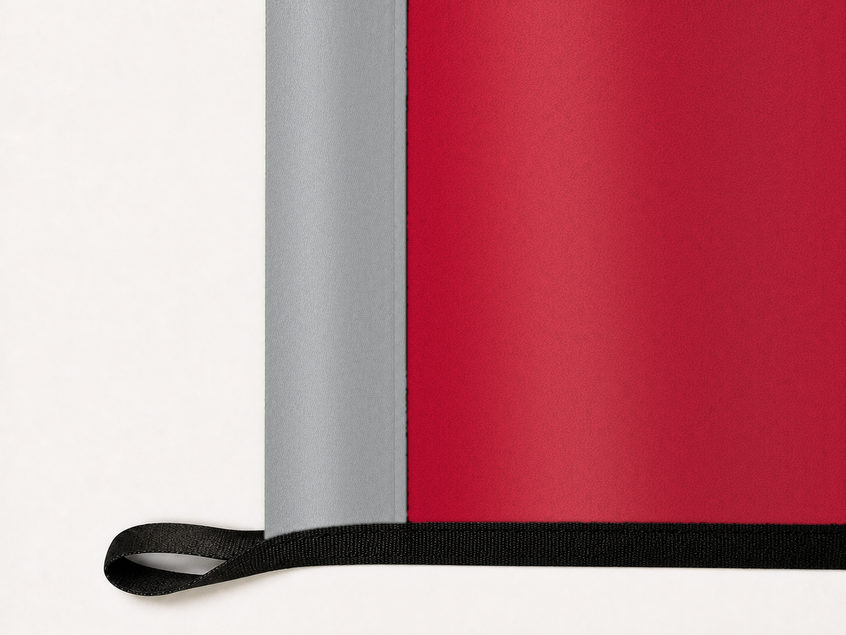 New Mexico Lobos Authentic Gameday Flag underside and personalization construction view — continuous restrained woven-satin New Mexico Lobos Accent header, textured New Mexico Lobos Primary face, lower black loop and perimeter webbing — source_sha256=a66dc58918b80f462e9dd03f4fb607ea9be2cd94d3ef0892219e5a3d6cc5c974