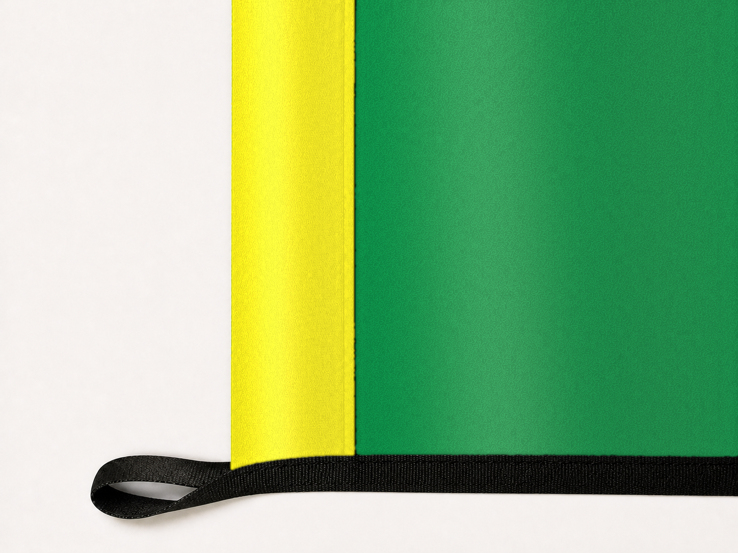 Oregon Ducks Authentic Gameday Flag underside and personalization construction view — continuous restrained woven-satin Oregon Yellow header, textured Oregon Green face, lower black loop and perimeter webbing — source_sha256=8cfcd23c0b23022c0a129cf5fc41cd9f98239ac07b884fdcca28c9cf17d866be