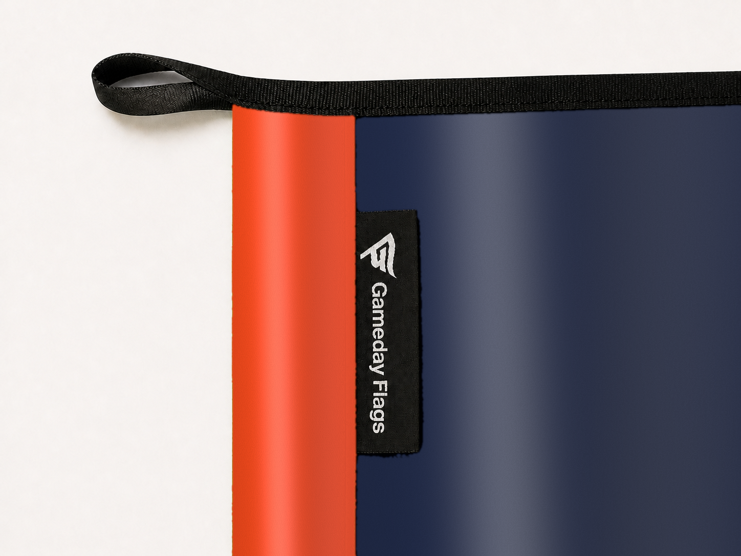 Virginia Cavaliers Authentic Gameday Flag construction detail — restrained woven-satin Virginia Cavaliers Accent sewn header, textured Virginia Cavaliers Primary face, woven Gameday Flags tag, black loop, perimeter webbing, and stitching — source_sha256=76f7fad3014542a84e9e0685f65c0348fdd9a442ec02b68fbf28d406939297bf