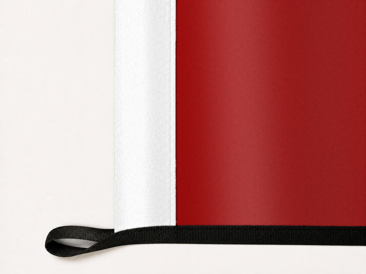 Wisconsin Badgers Authentic Gameday Flag underside and personalization construction view — continuous restrained woven-satin Wisconsin Badgers Accent header, textured Wisconsin Badgers Primary face, lower black loop and perimeter webbing — source_sha256=f488c6323d088ac815e40197a0025ba2bd200b9687ceec7c3cf067a95e6c7b39