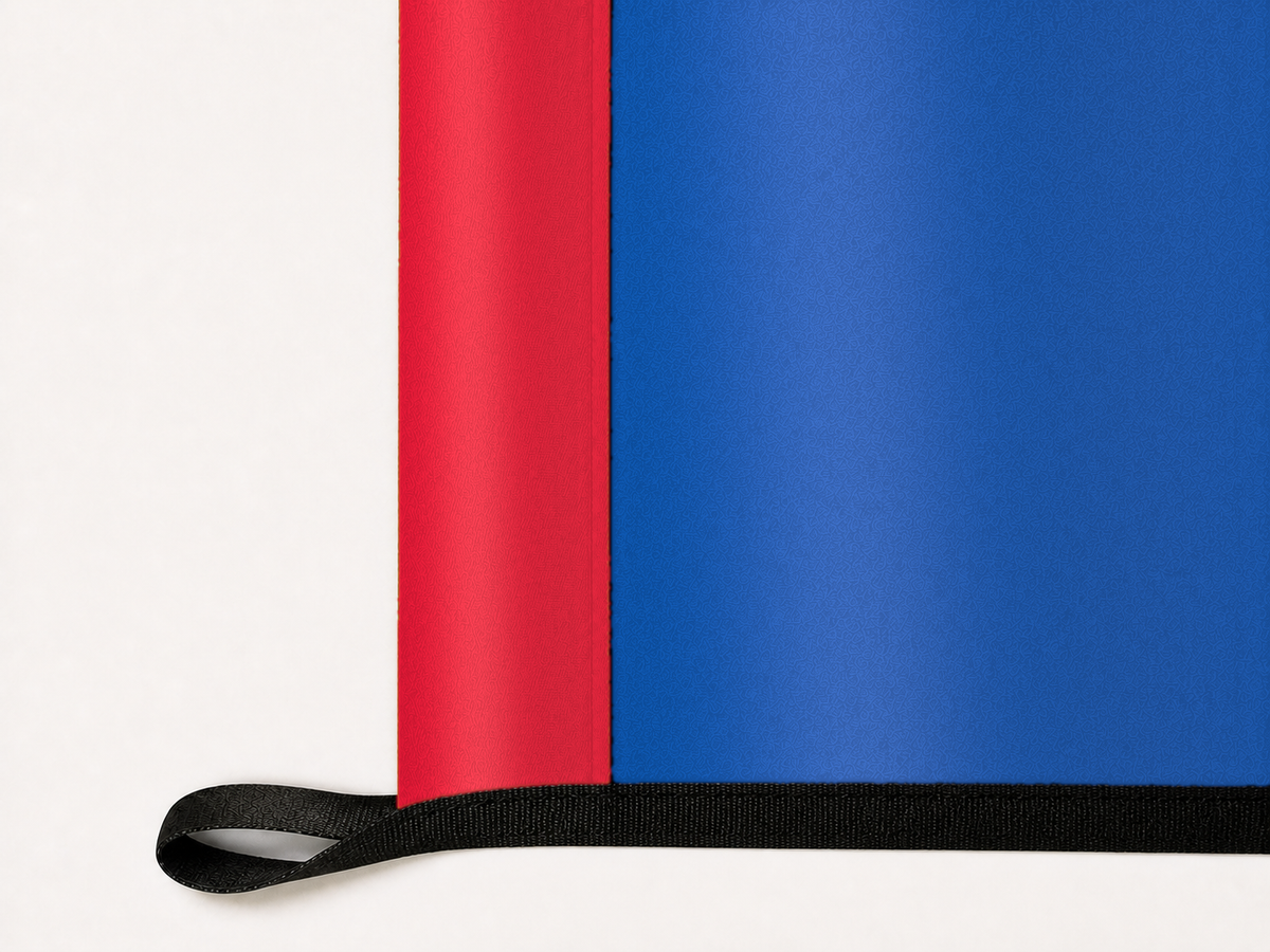 New York Rangers Authentic Gameday Flag underside and personalization construction view — continuous restrained woven-satin New York Rangers Accent header, textured New York Rangers Primary face, lower black loop and perimeter webbing — source_sha256=72e126c7a688484fc5d71092b3235e733a734f7101a72ab0aed61d280282c35c