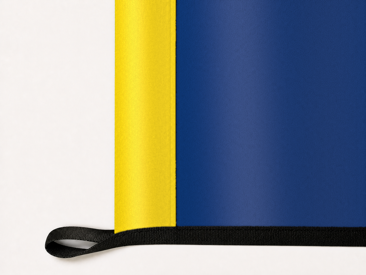 Idaho State Flag Authentic Gameday Flag underside and personalization construction view — continuous restrained woven-satin Idaho State Flag Accent header, textured Idaho State Flag Primary face, lower black loop and perimeter webbing — source_sha256=047db51173a40325aca4574566b9b5f461a0facb432d3d7ca0e4cefff783c7ad