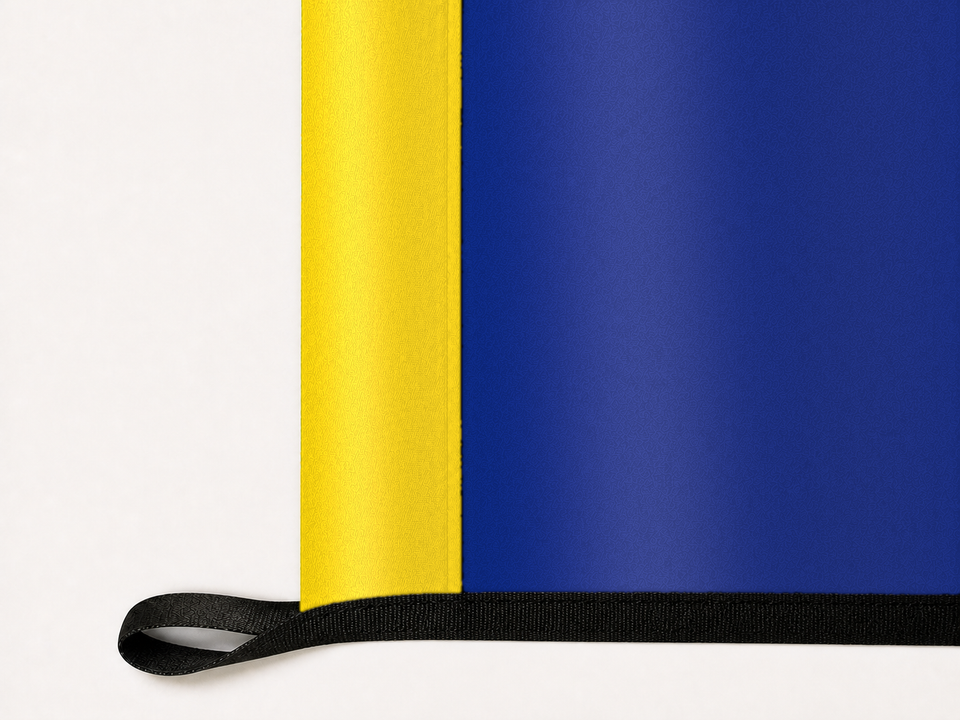 Nebraska State Flag Authentic Gameday Flag underside and personalization construction view — continuous restrained woven-satin Nebraska State Flag Accent header, textured Nebraska State Flag Primary face, lower black loop and perimeter webbing — source_sha256=54973ec3bbc62ee66e28effc819b6695b43b5b5d5953b2970703971e8251bb38