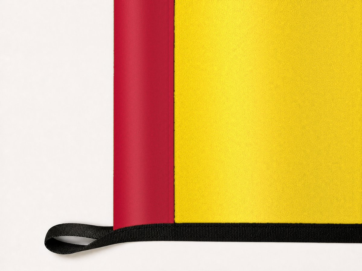 New Mexico State Flag Authentic Gameday Flag underside and personalization construction view — continuous restrained woven-satin New Mexico State Flag Accent header, textured New Mexico State Flag Primary face, lower black loop and perimeter webbing — source_sha256=8dee5f00af96872d807140f1d916c417e8275f62a019f7805352680d8fcba68a