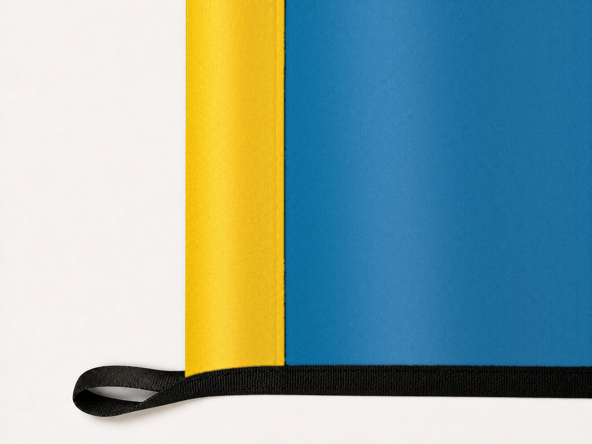 South Dakota State Flag Authentic Gameday Flag underside and personalization construction view — continuous restrained woven-satin South Dakota State Flag Accent header, textured South Dakota State Flag Primary face, lower black loop and perimeter webbing — source_sha256=e2265387ec894d299fb47a2d87048edd916428109754d88b919eb98ef6d8b6f0