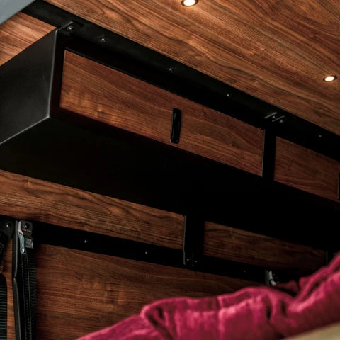Virtus Vans black aluminum and walnut storage cabinets installed inside a Sprinter van